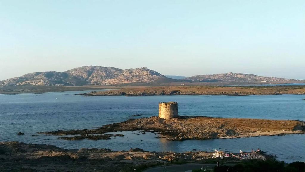 an island with a tower in the middle of the water at B&B Il Gatto Pescatore in Stintino