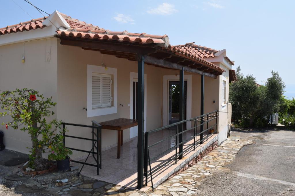 a porch of a house with a balcony at Villa Ioanna in Koroni