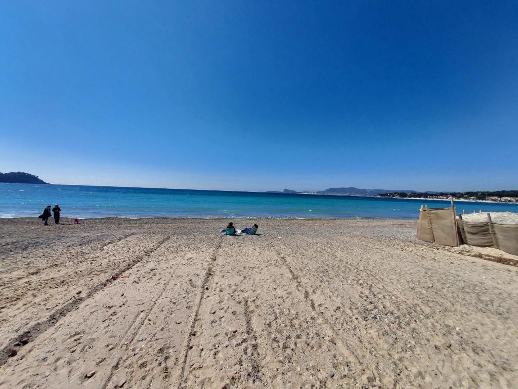 a group of people sitting on a beach at T3 au bord de mer in Saint-Cyr-sur-Mer
