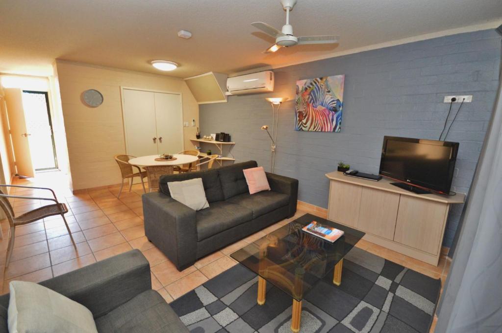 a living room with a couch and a tv at Riverview Holiday Apartment 106 - Kalbarri, WA in Kalbarri