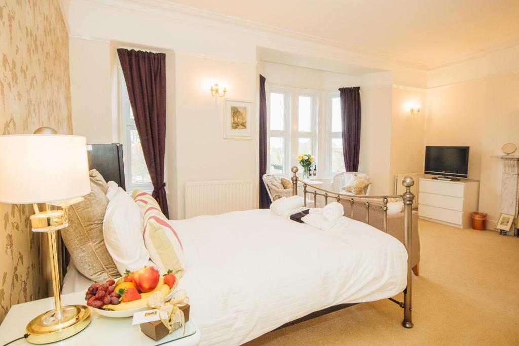 a bedroom with a bed with a bowl of fruit on a table at EveAnna in Alnwick