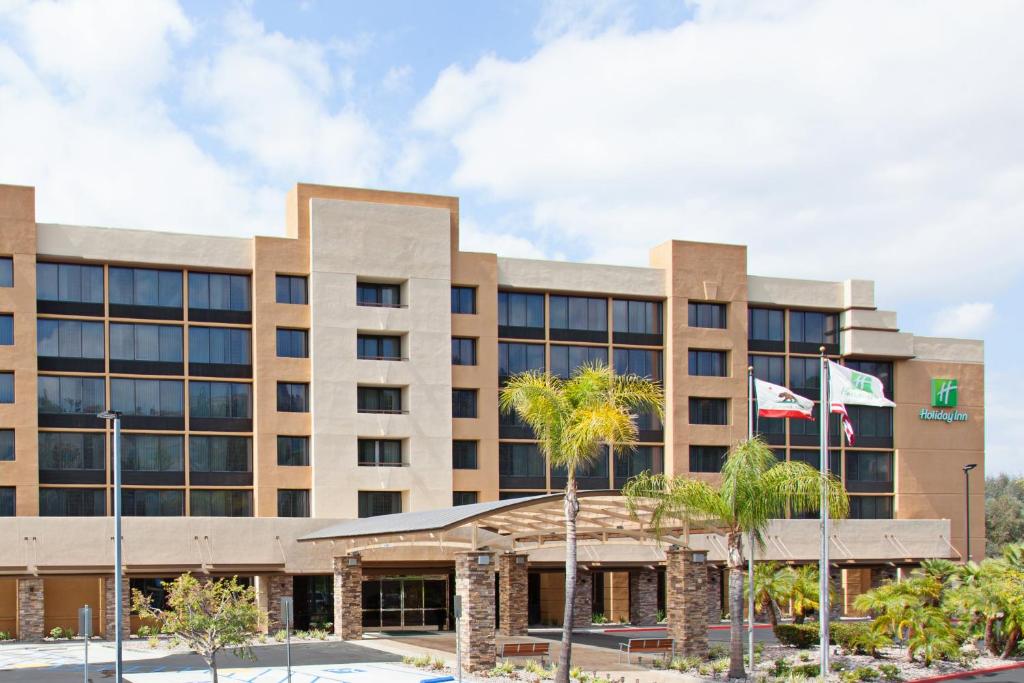 an office building with two flags in front of it at Holiday Inn Diamond Bar - Pomona, an IHG Hotel in Diamond Bar