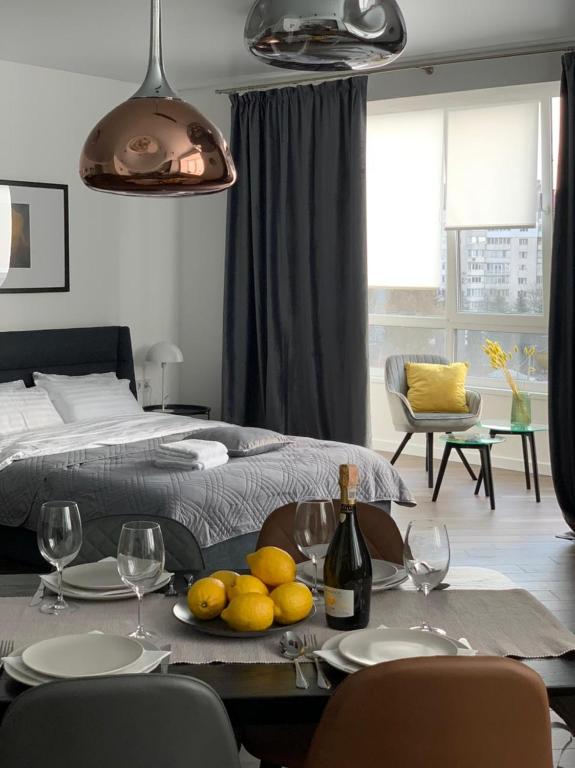 a dining table with a plate of lemons and wine bottles at Central Apartments Апартаменти в центрі in Khmelnytskyi