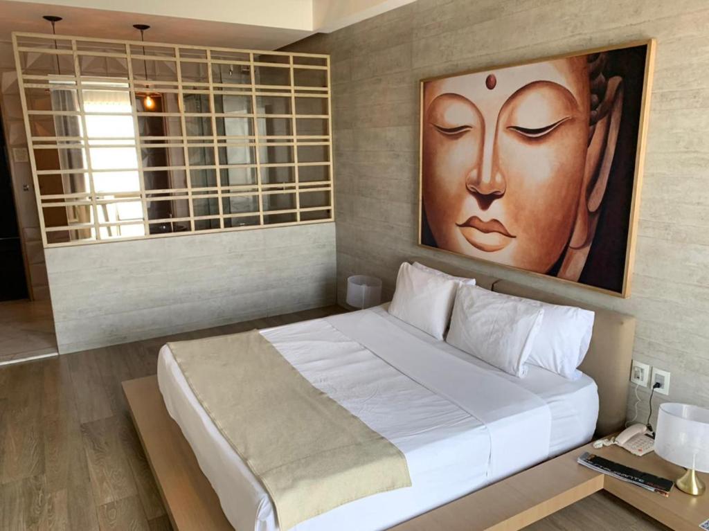 Postel nebo postele na pokoji v ubytování Motel Okura Villas y Suites