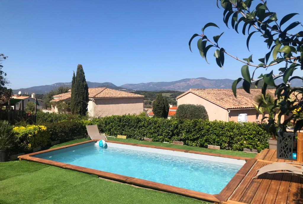 a swimming pool in the yard of a house at RINESA II in Porticcio