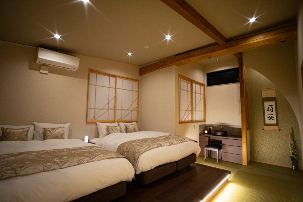 Postel nebo postele na pokoji v ubytování Ixyz別邸 月夜見の宿