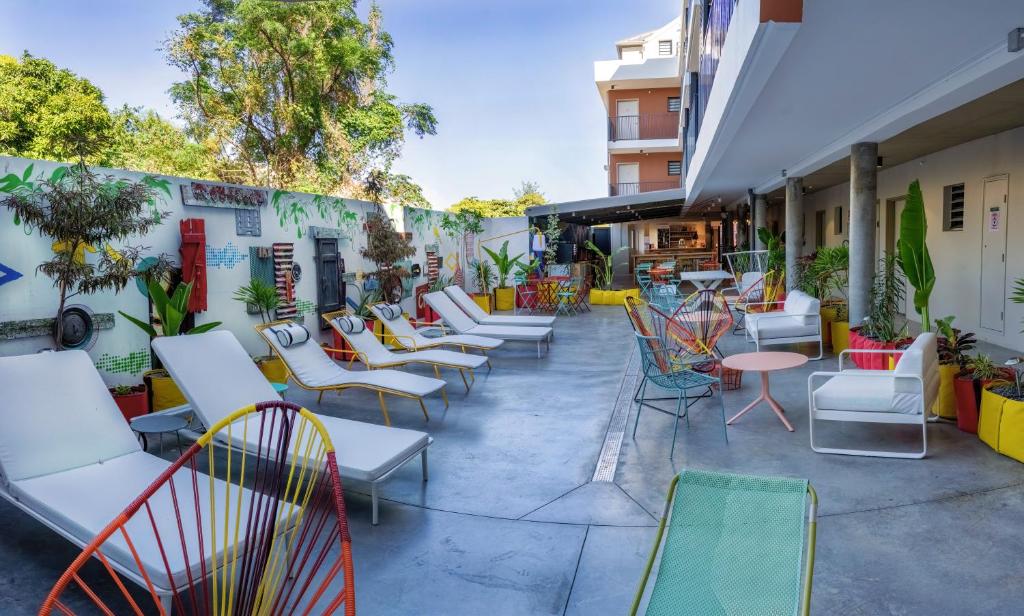 a row of chairs and tables on a patio at HÔTEL LE TERRE SAINTE in Saint-Pierre