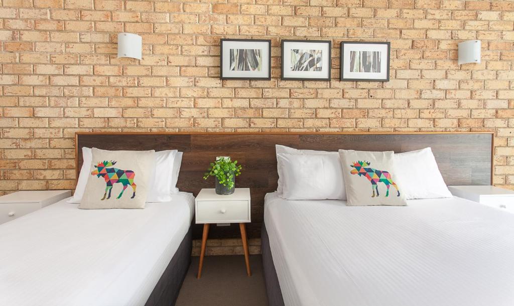 Postel nebo postele na pokoji v ubytování Sunshine Coast Motor Lodge