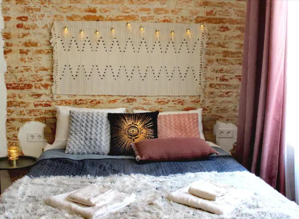 a bedroom with a bed with towels on it at Dorosh-HOME квартира-студія в центрі Львова in Lviv