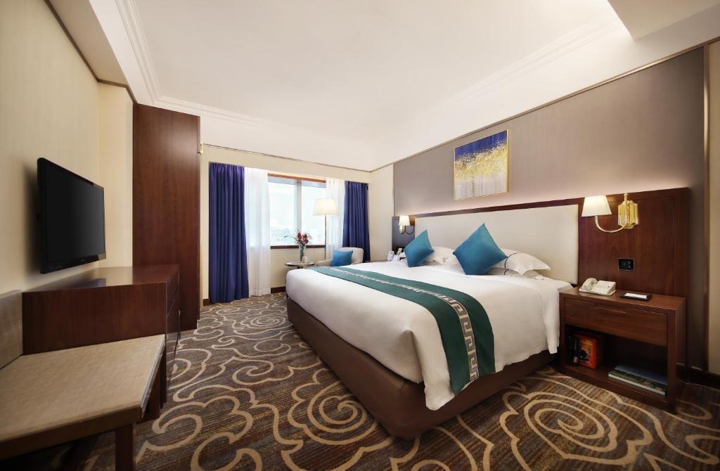 Postel nebo postele na pokoji v ubytování Asia International Hotel Guangdong