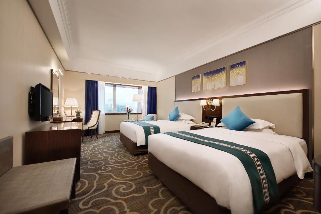 Postel nebo postele na pokoji v ubytování Asia International Hotel Guangdong
