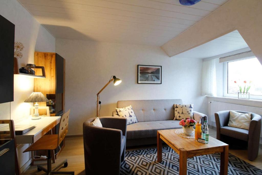a living room with a couch and a table at FeWo-2-OG-rechts in Sankt Peter-Ording