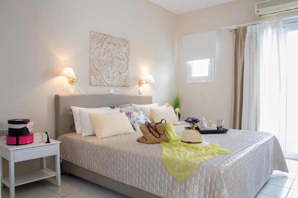 a bedroom with a bed with two hats on it at Windmill Beach Apts II by Estia in Malia