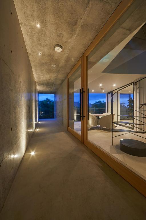 a room with large windows and a living room at E-horizon Resort Premium 瀬底E in Sesoko