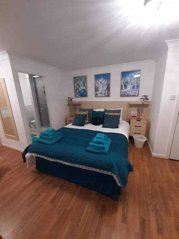 a bedroom with a large bed with blue sheets at North Shore Lodge Skegness in Skegness