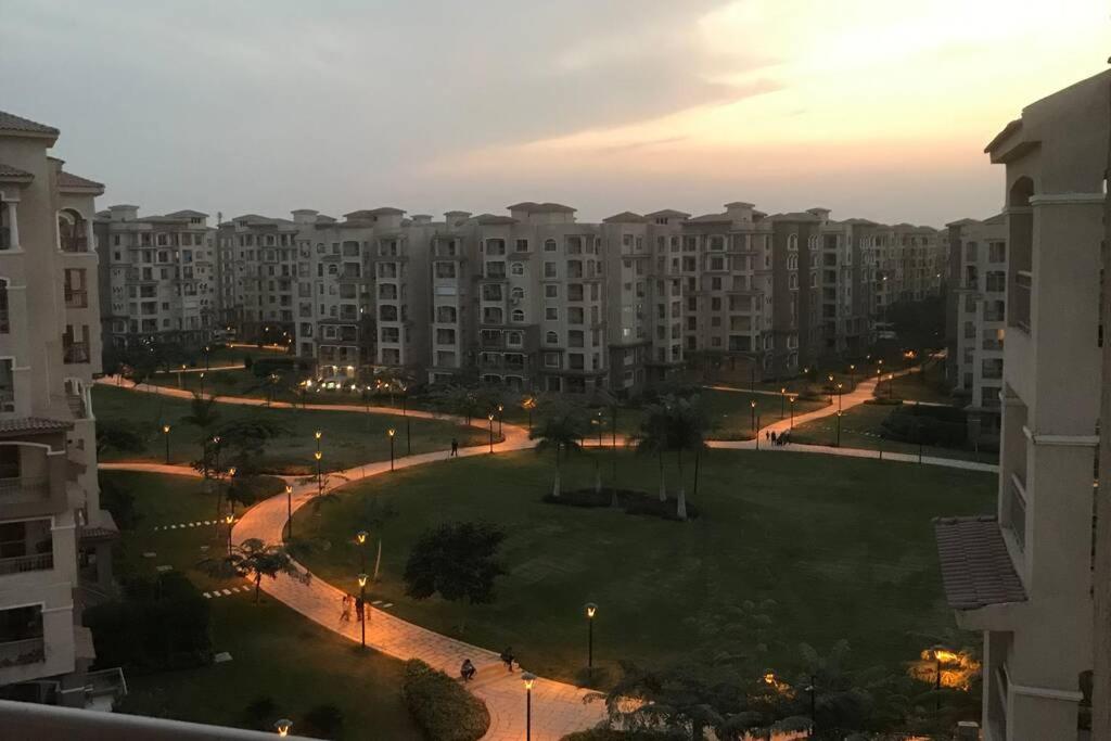 a view of a park with large apartment buildings at Executive 2 BedRoom Hotel Apmt Contactless check-in Premium Services and Quality at Madinaty in Madīnat ash Shurūq