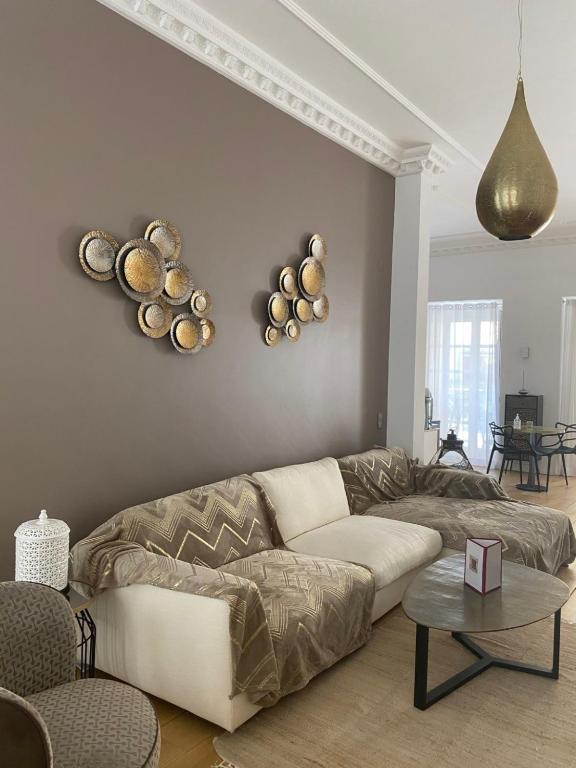 a living room with a couch and bowls on the wall at Villa Zawaia B&B in Lagos