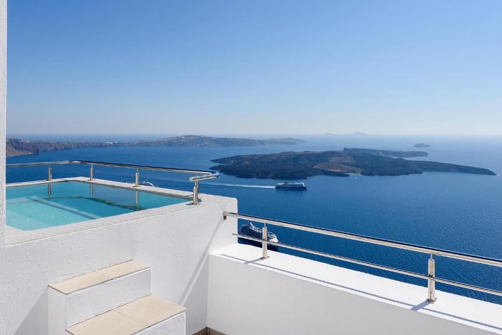 a view of the ocean from the balcony of a house at Spitia Tzitzi in Imerovigli