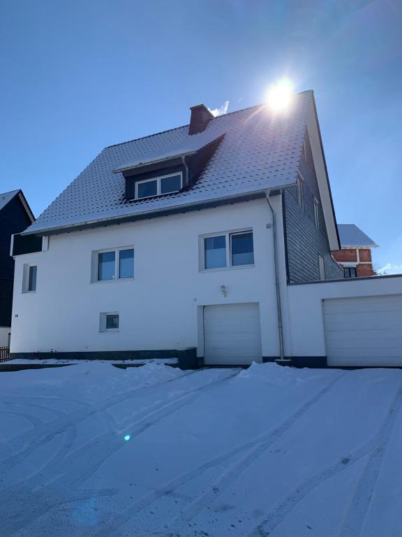 a white house with a light on top of it at Ferienwohnung Bergstraße in Winterberg