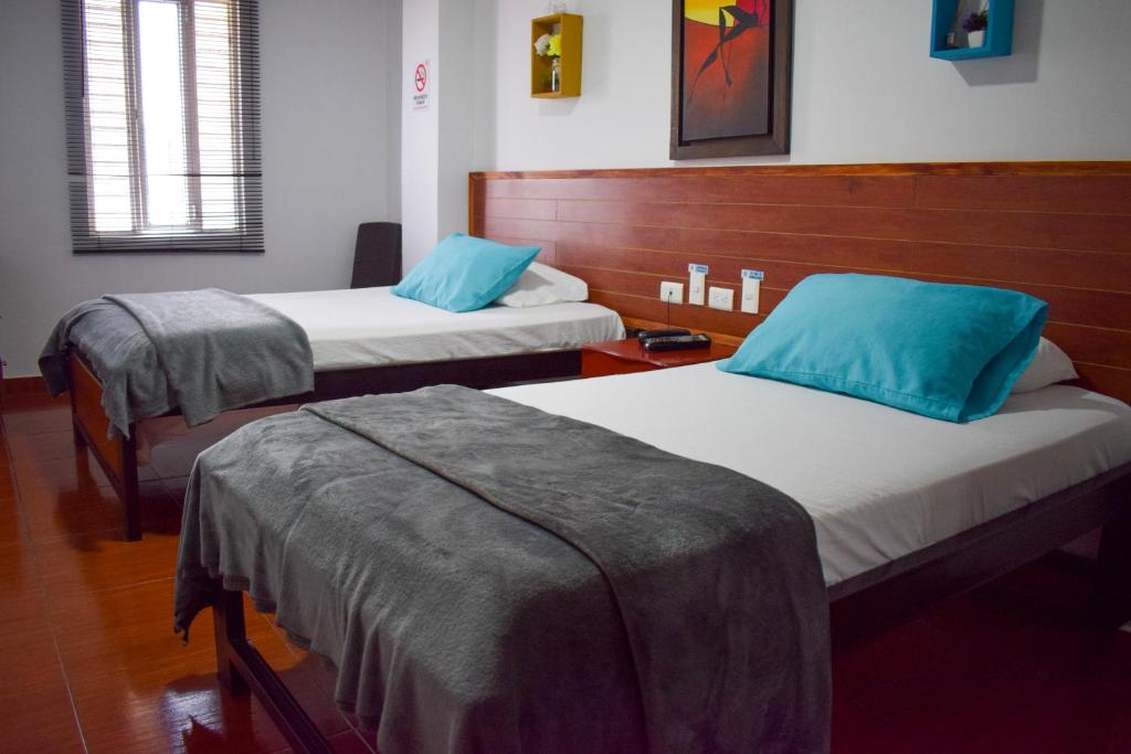 Postel nebo postele na pokoji v ubytování Hotel Brisas De Calima