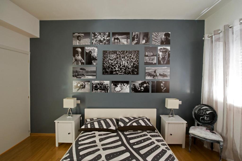 a bedroom with a gray wall with pictures on it at The Photos Room B&B in Rome