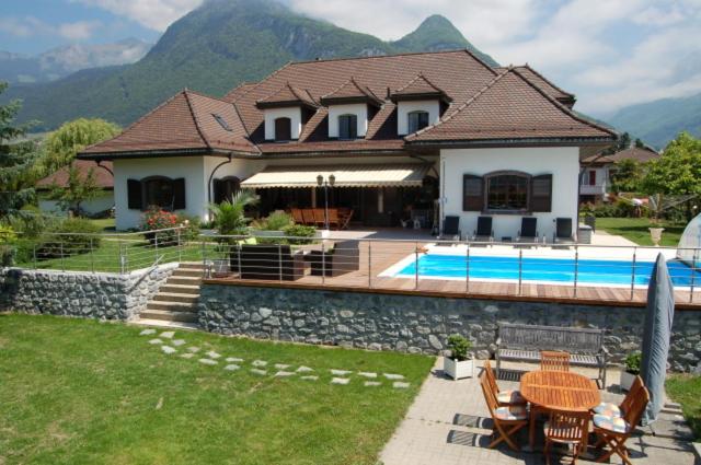 a house with a swimming pool next to a house at B&B L'Eden in Aigle