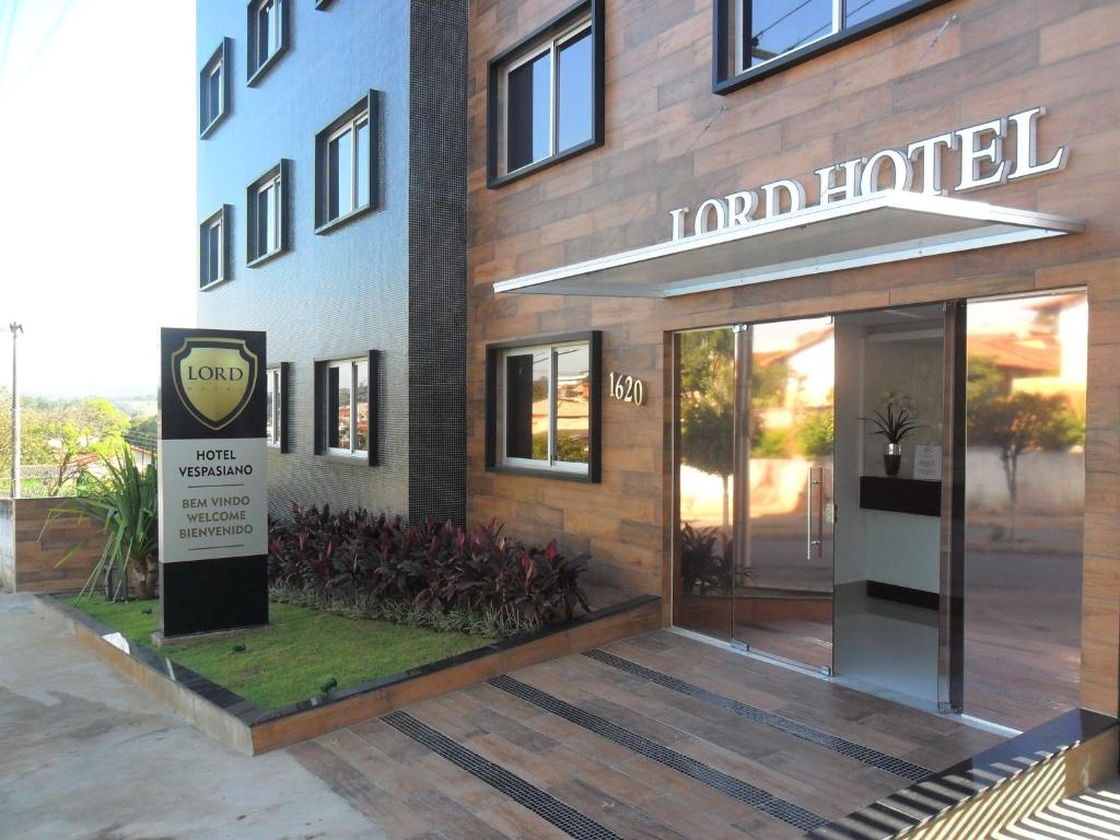 a hotel with a sign in front of a building at Lord Hotel Aeroporto Confins in Vespasiano