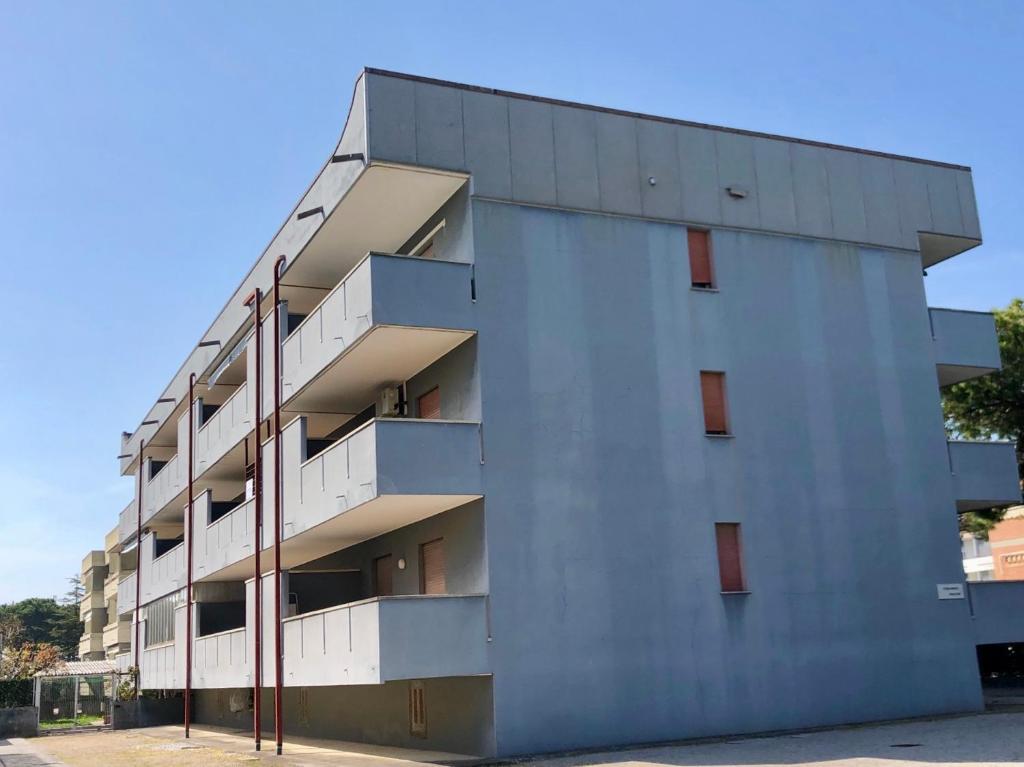 a building with balconies on the side of it at Mirafiori Apartment in Grado