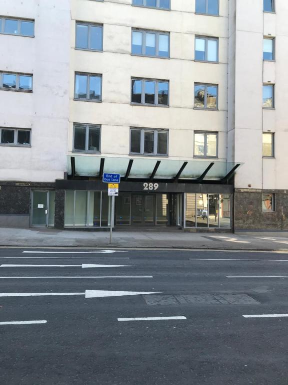 an empty street in front of a building at Apex Variety Gate Apartment in Glasgow