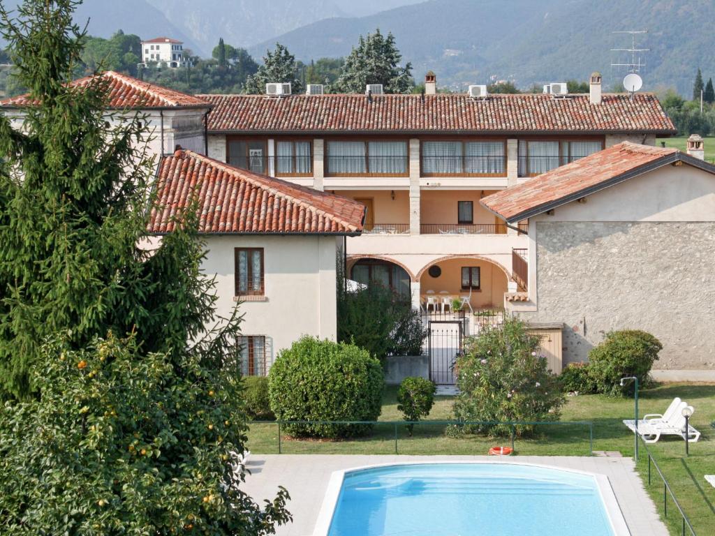 a villa with a swimming pool in front of a house at Holiday Home Villetta by Interhome in San Felice del Benaco