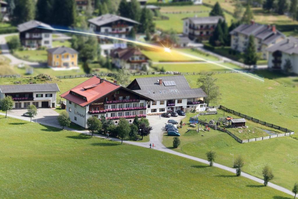 an aerial view of a large house with a lawn at Pension Königshof in Mallnitz