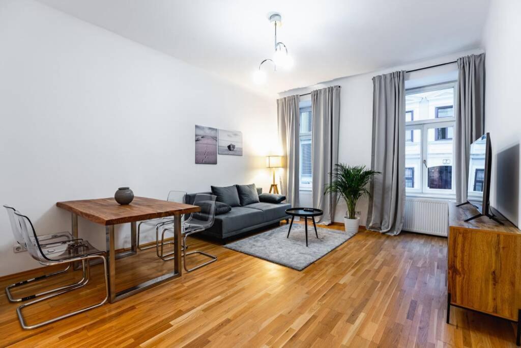 a living room with a couch and a table at Spacious 3-room apt. 15 min to the city center in Vienna