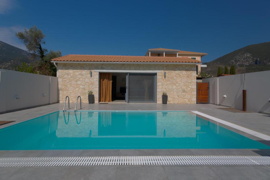 a swimming pool in front of a villa at Amoroza Villa in Nydri