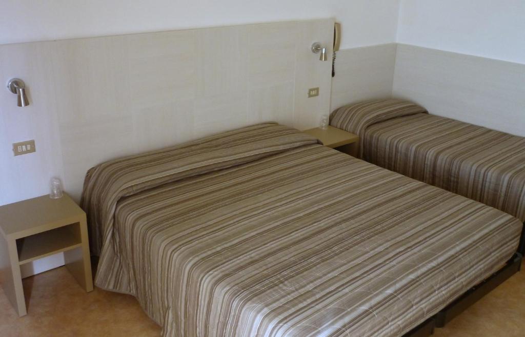 Postel nebo postele na pokoji v ubytování Hotel Solemare