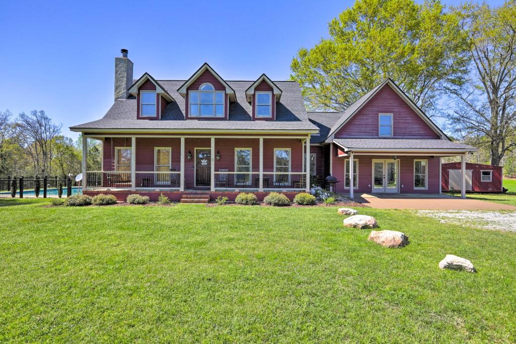 a house with a large yard with rocks in front of it at Private Pool & Deck: Quiet Countryside Escape in Hamilton
