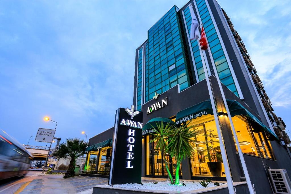 a building with a sign in front of it at Avwan Hotel Çiğli in Izmir
