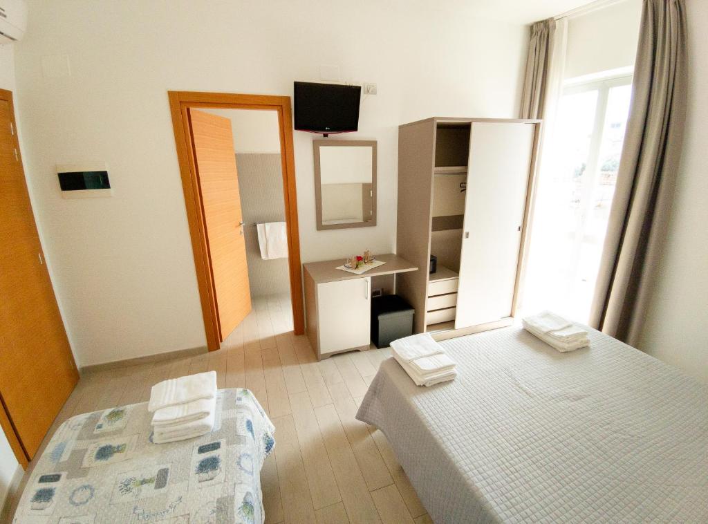 Postel nebo postele na pokoji v ubytování Hotel Capitano
