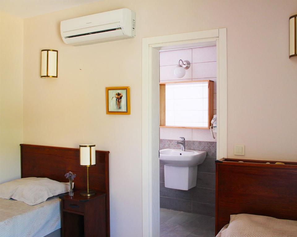 Postel nebo postele na pokoji v ubytování Mitos Hotel