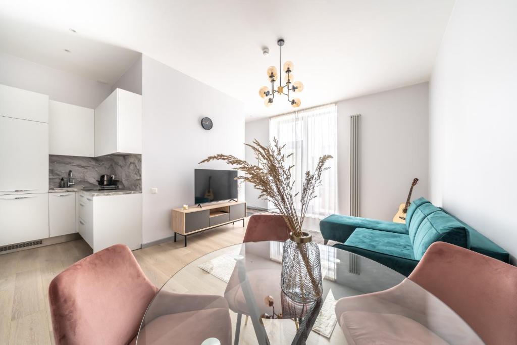 a living room with a glass table and chairs at New Comfortable 2 Bedroom Cottage w/Big Terrace in Jūrmala