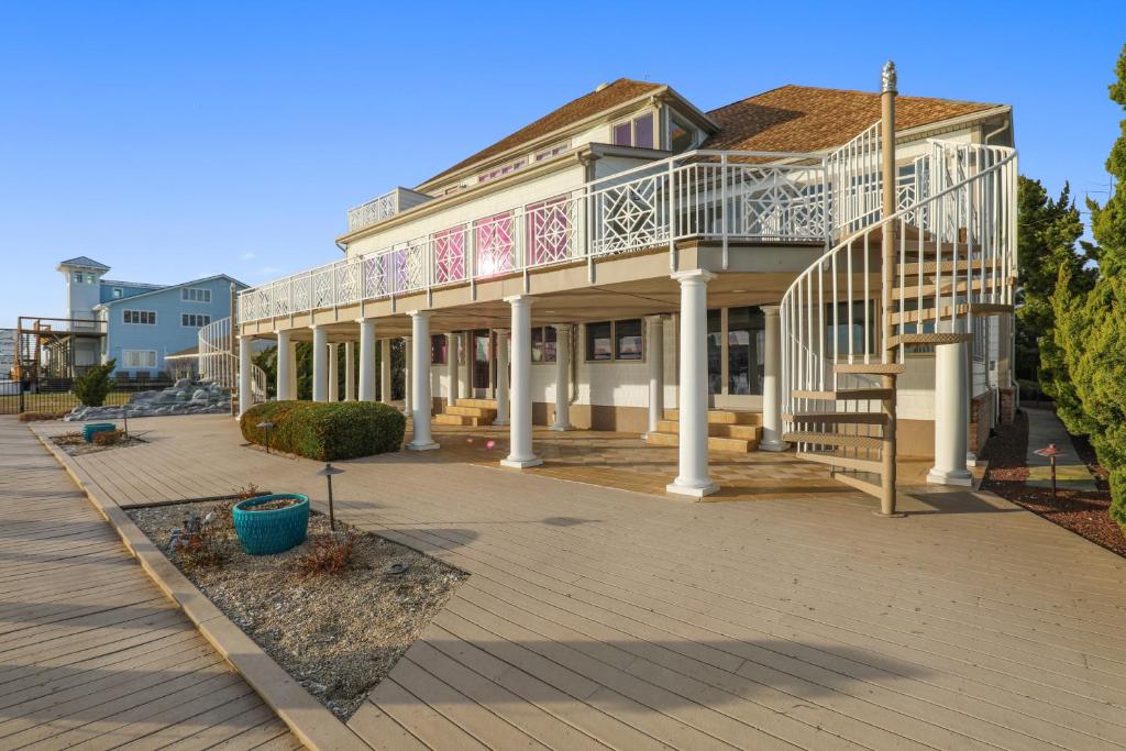 a large building with a balcony and a staircase at Sunset Getaway in Ocean City