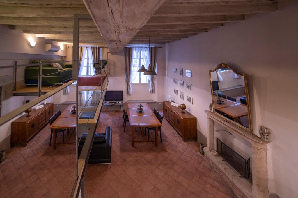 a large room with a table and a mirror at BRIXIA LUXORY & LOFT in Brescia