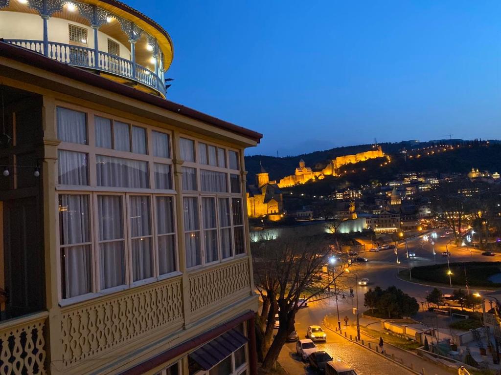 a view of a city at night from a building at Apartment Tamarioni in Tbilisi City