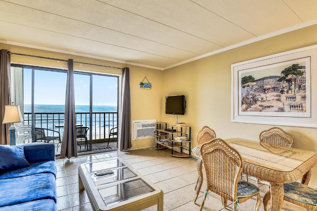 a living room with a view of the ocean at East Winds 505 in Ocean City