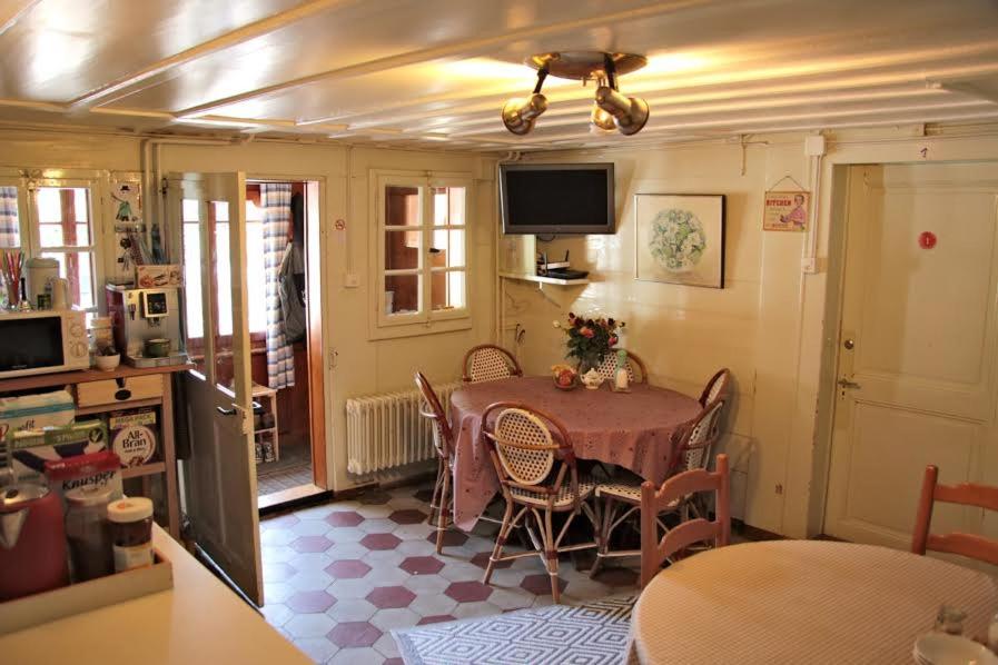 a kitchen with a table and chairs in a room at Chalet la Griotte in Villars-sur-Ollon