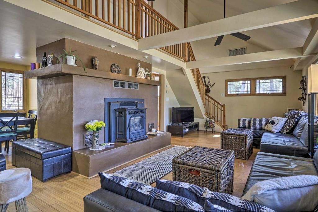 a living room with couches and a fireplace at Dog-Friendly Cabin Near Tonto National Forest! in Payson