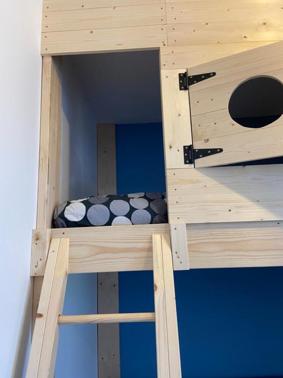 two wooden bunk beds in a room at Les pieds dans l eau in Erpion