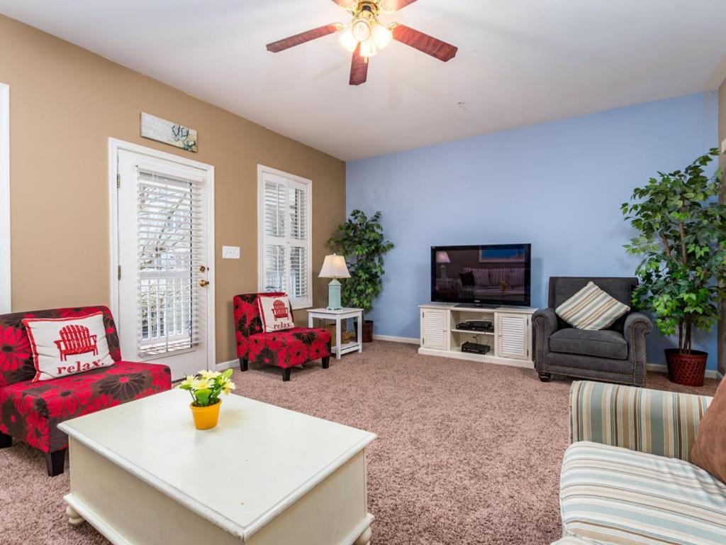 a living room with a couch and a tv at Sunset Island - 22 Island Edge in Ocean City