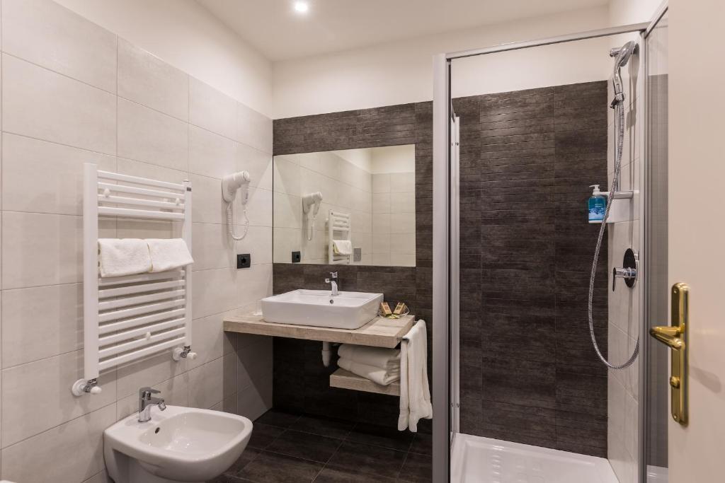 a bathroom with a sink and a shower at Brione Green Resort in Riva del Garda