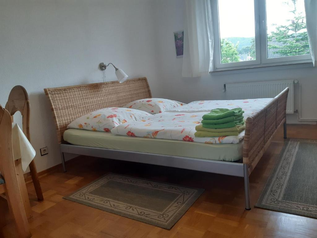 a bedroom with a bed with towels on it at Haus Andreasse am Wiehengebirge in Minden