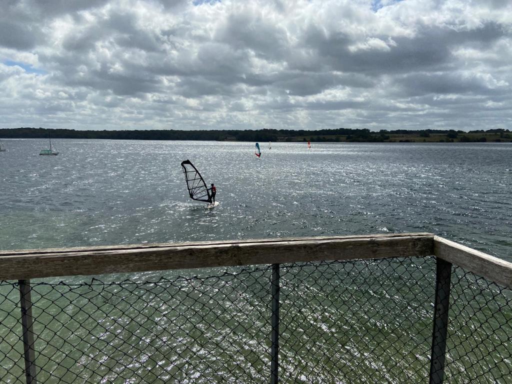 a person in the water with a sail in the water at Les pieds dans l eau in Erpion